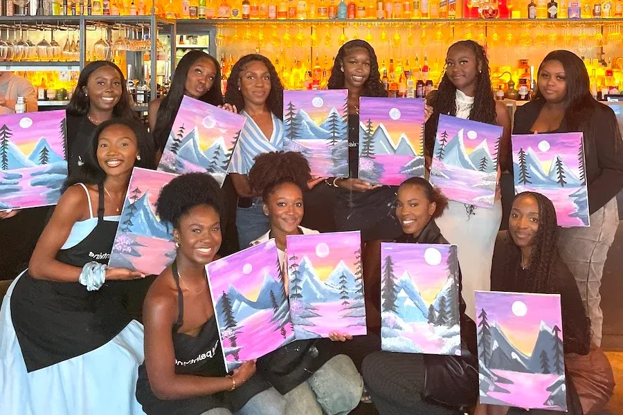 Painter with colorful hands at paint night